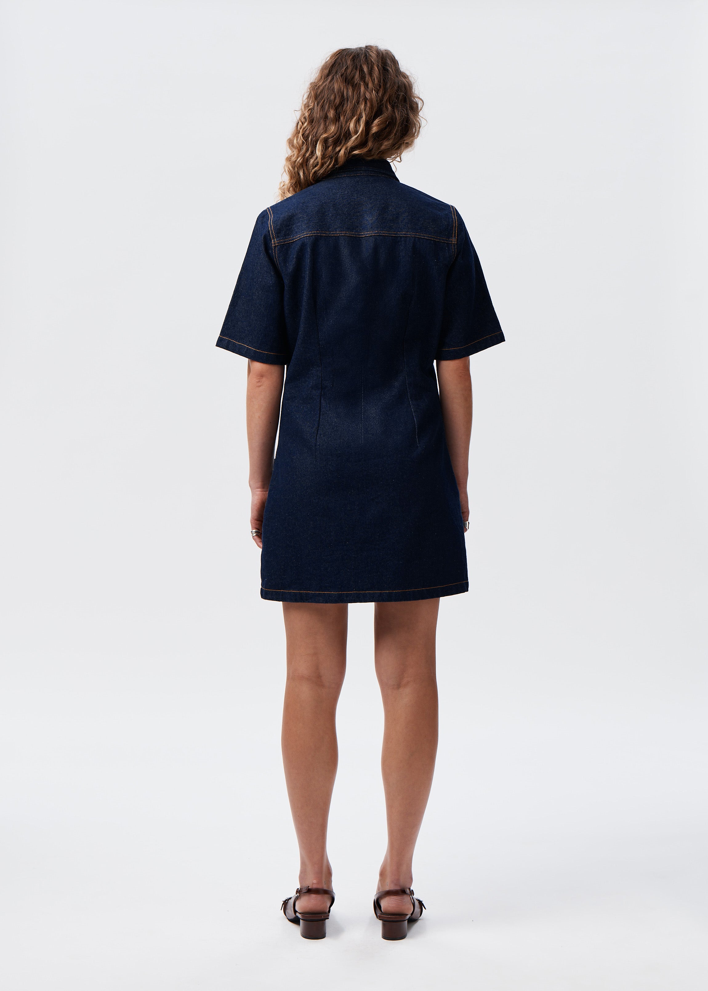 Model wearing the Say the Label Wave Denim Dress, back view