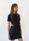 Say the Label Daisy Asymmetric Top in noir black with daisy embroidery, worn with a black skirt