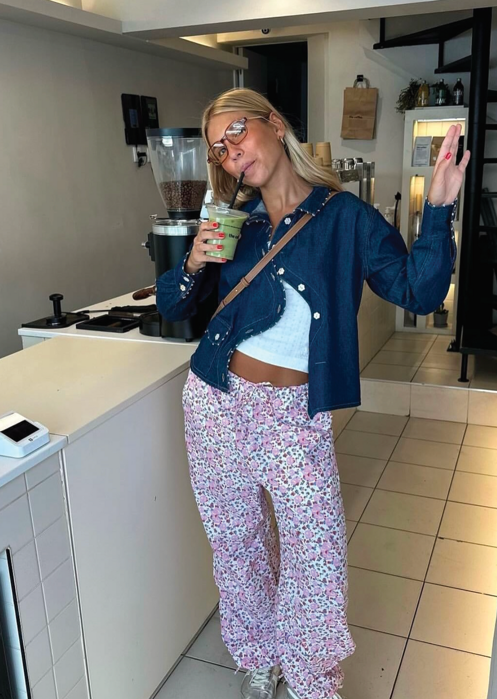 Say the Label Wave Denim Jacket worn open over a white top with floral-print pants