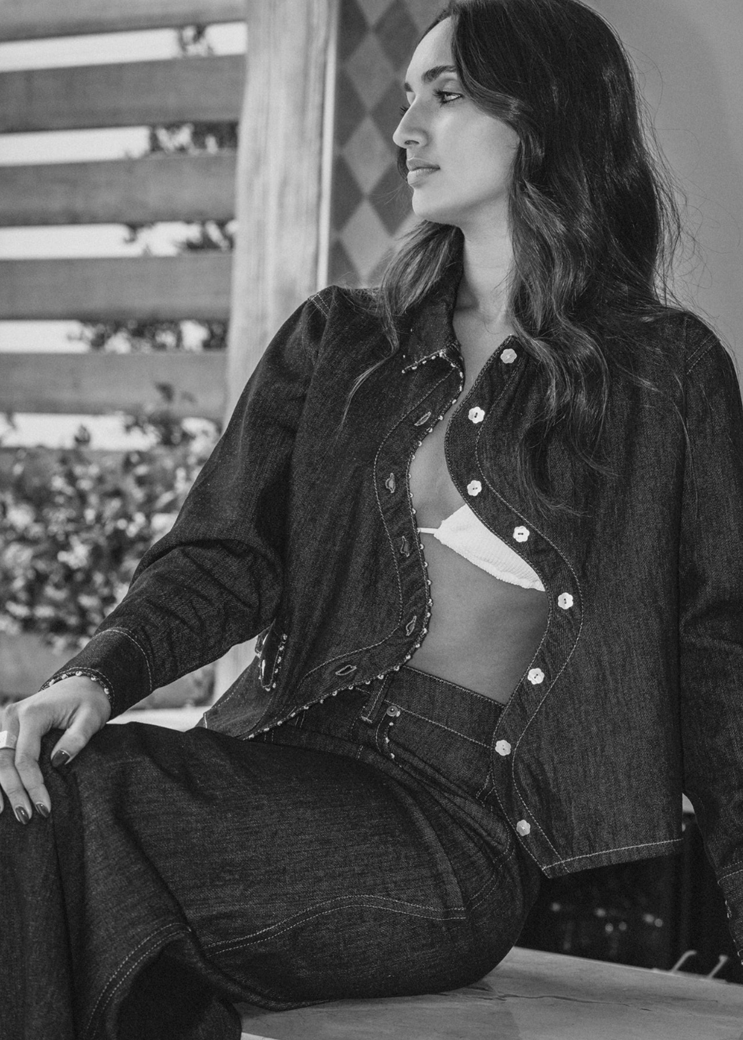 Model wearing the Say the Label Wave Denim Jacket with matching jeans, black and white editorial shot